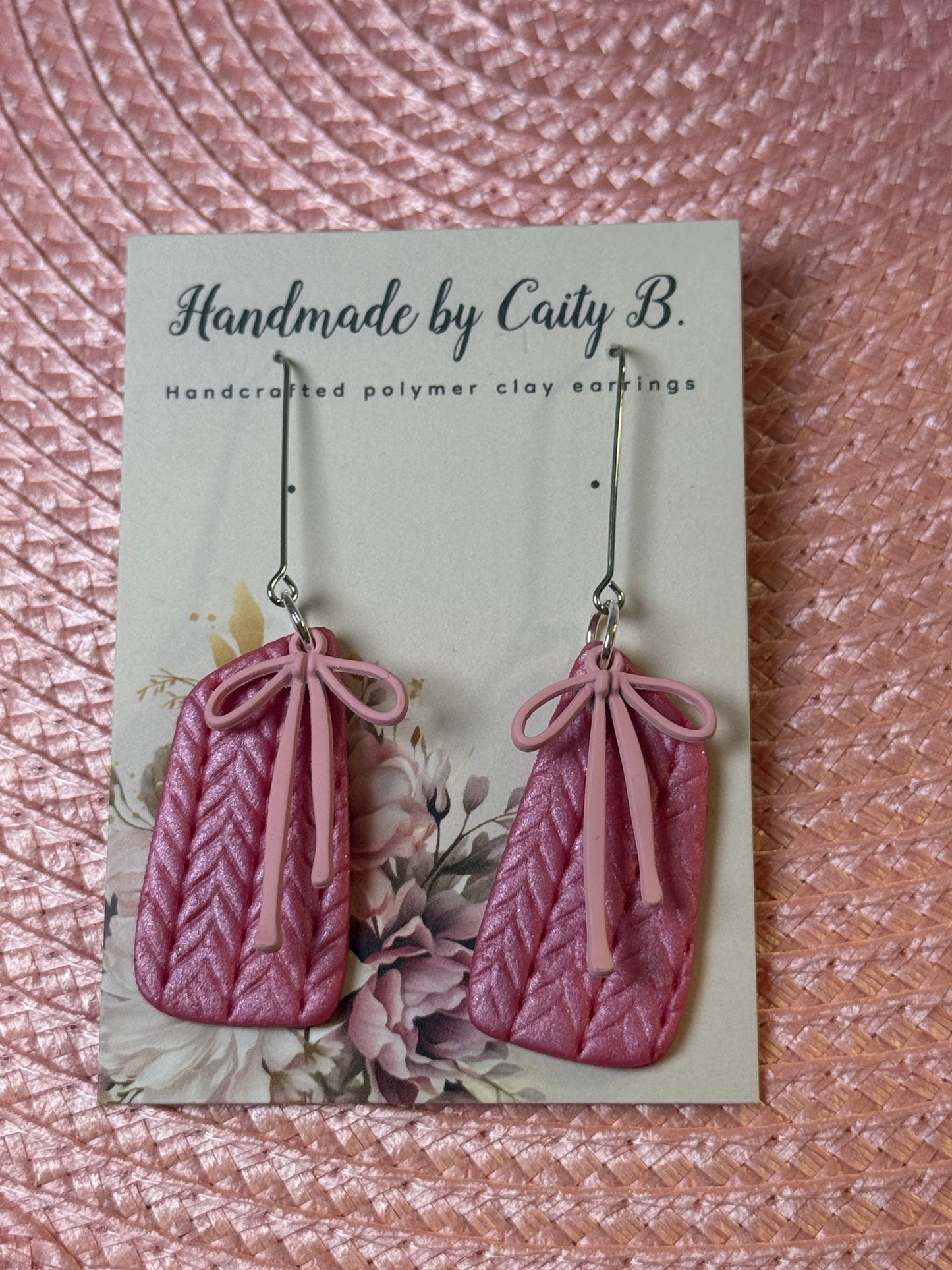 pink shimmer knitted texture earrings with pink bow charms
