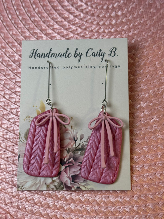 pink shimmer knitted texture earrings with pink bow charms