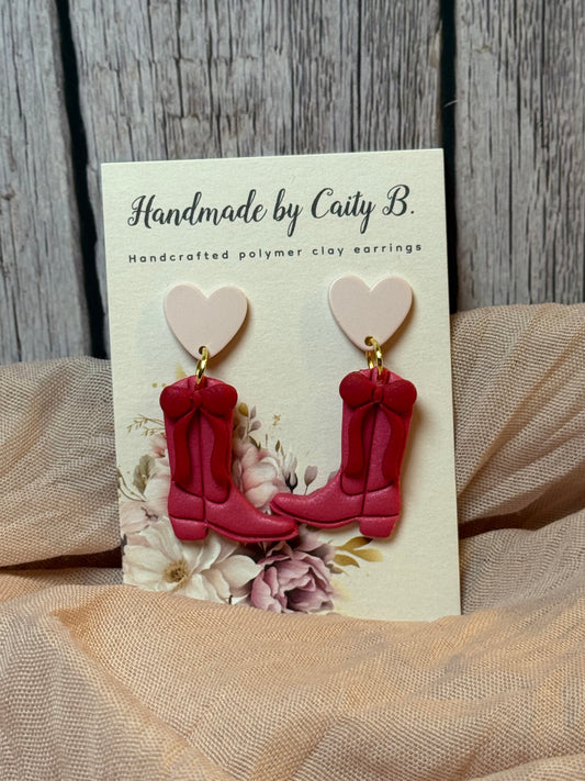 pink boots with red bows and heart toppers