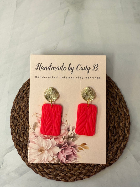 Pink textured earrings with gold circle top