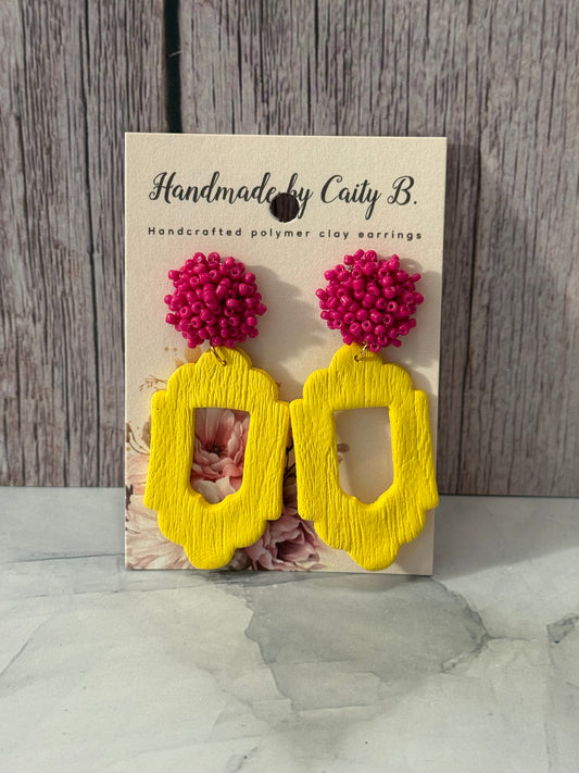 yellow frames with pink beaded top