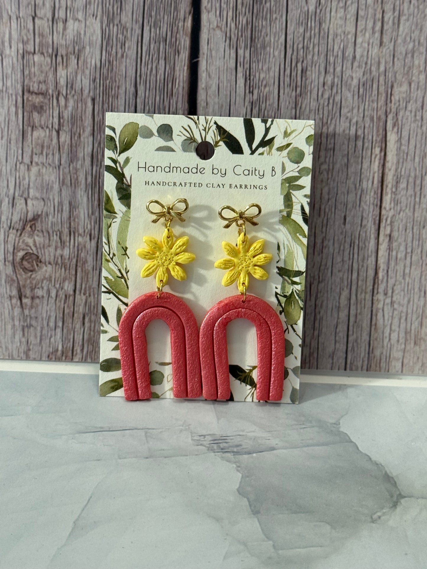 pink arch with yellow flowers and gold bows