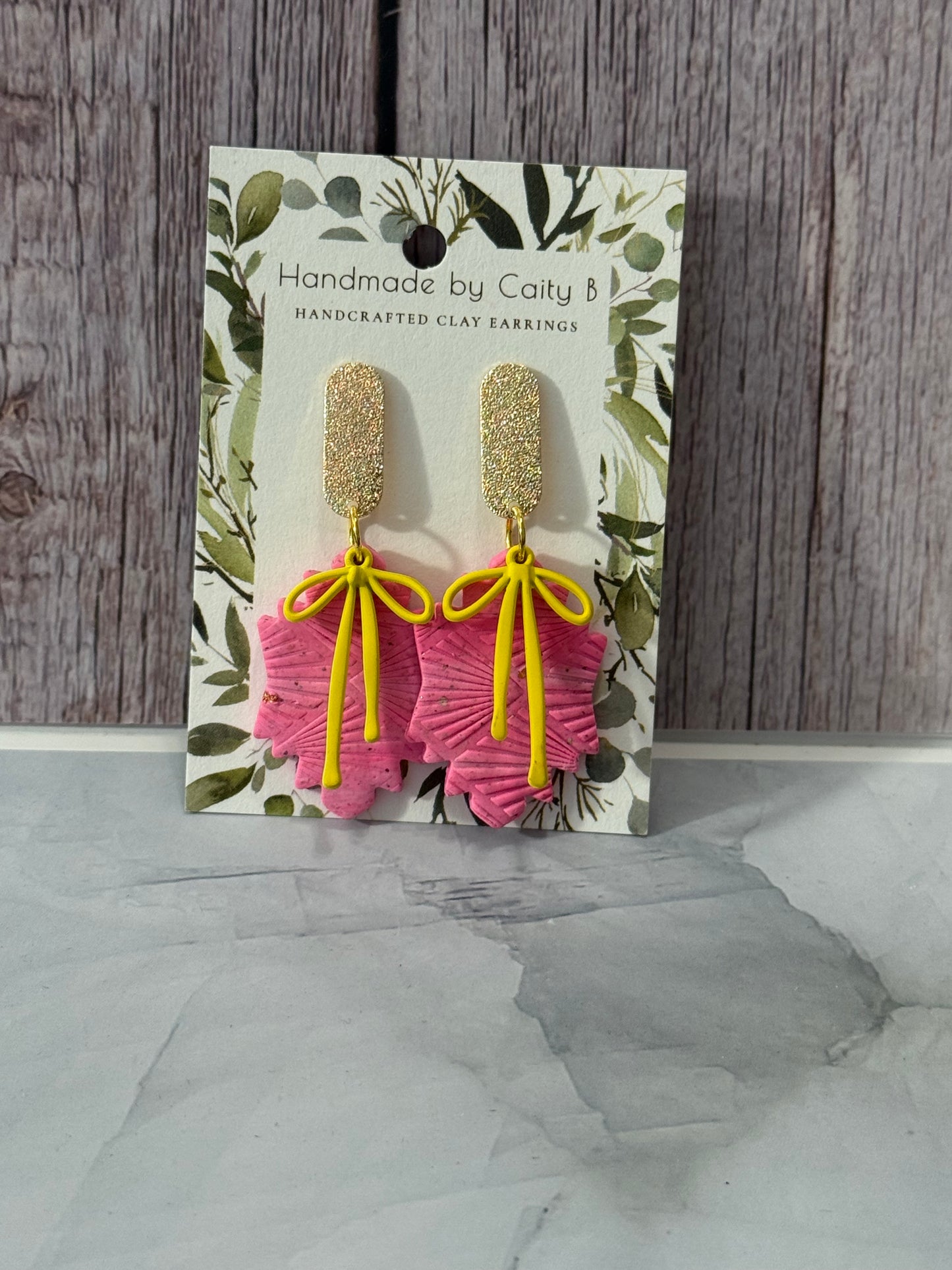 pink dangles with yellow bows