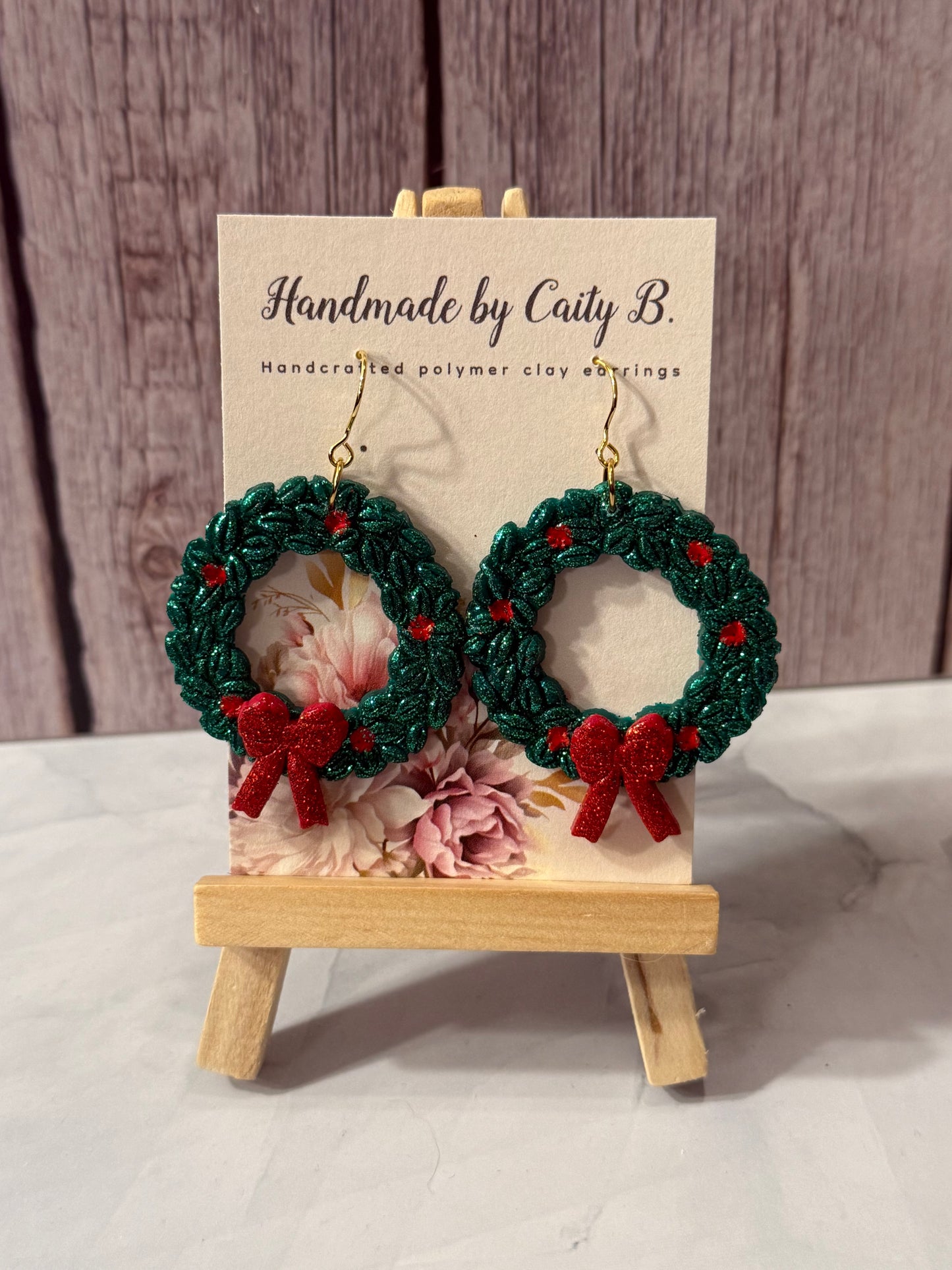 glitter wreaths with holly and red bows