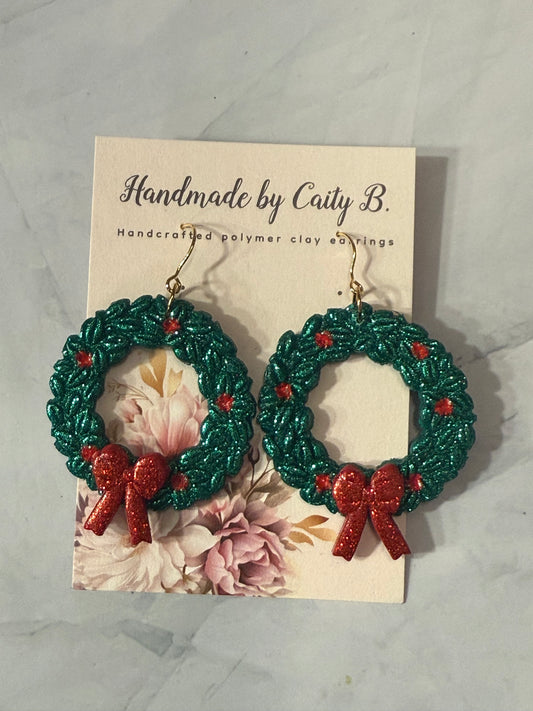 glitter wreaths with holly and red bows