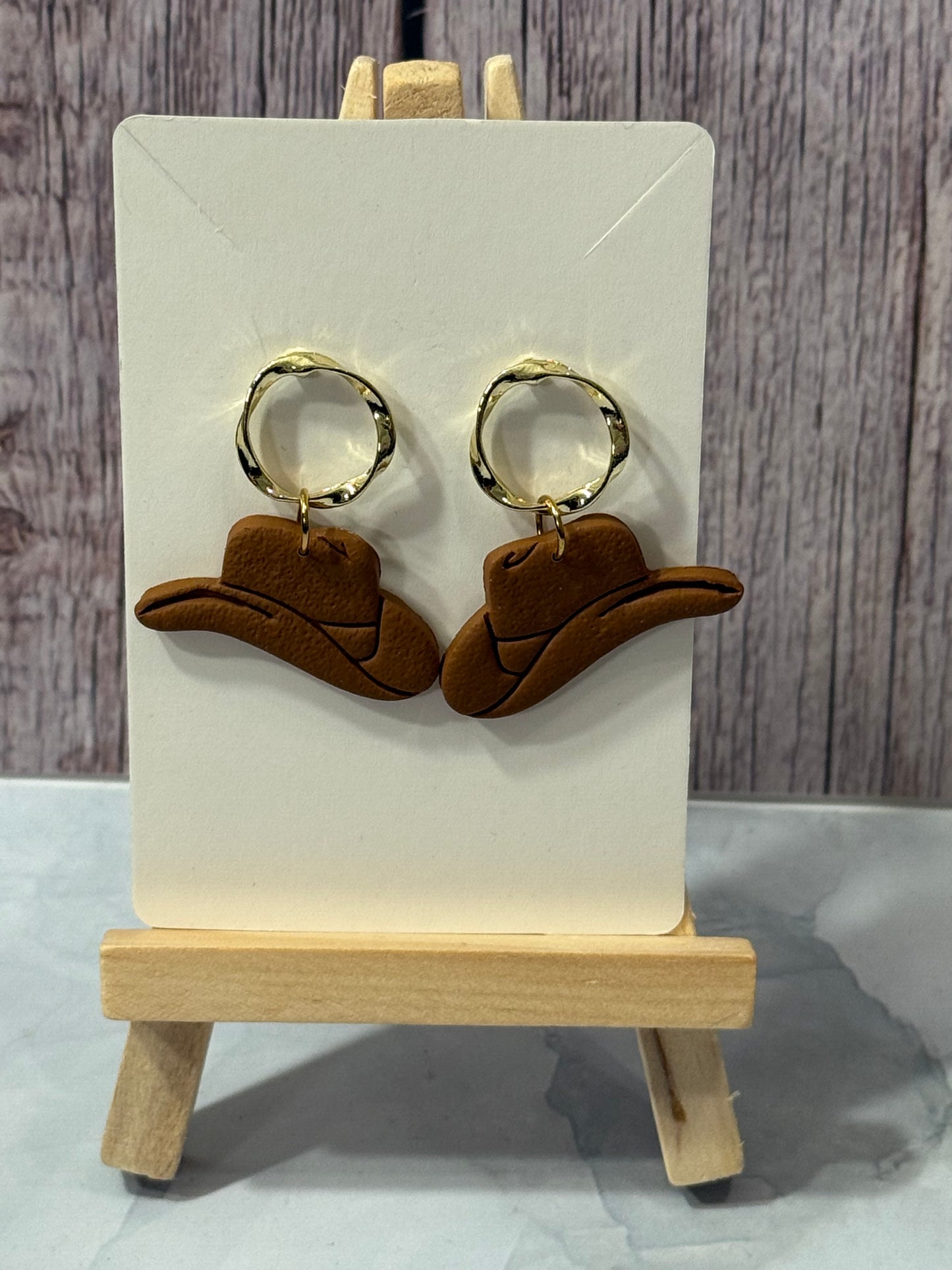 Cowboy hats with gold circle tops