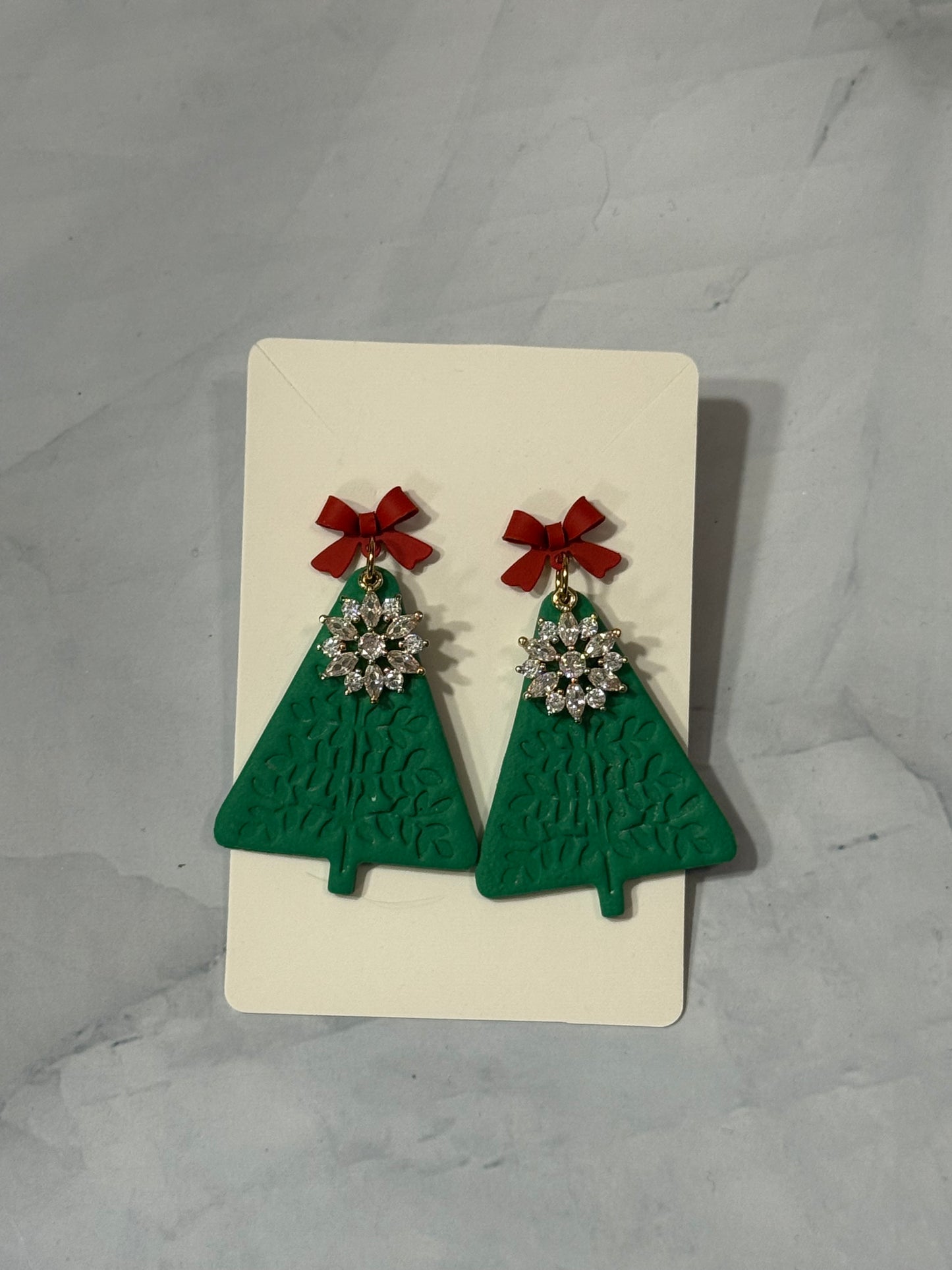 Christmas trees with snowflake charm and red bows