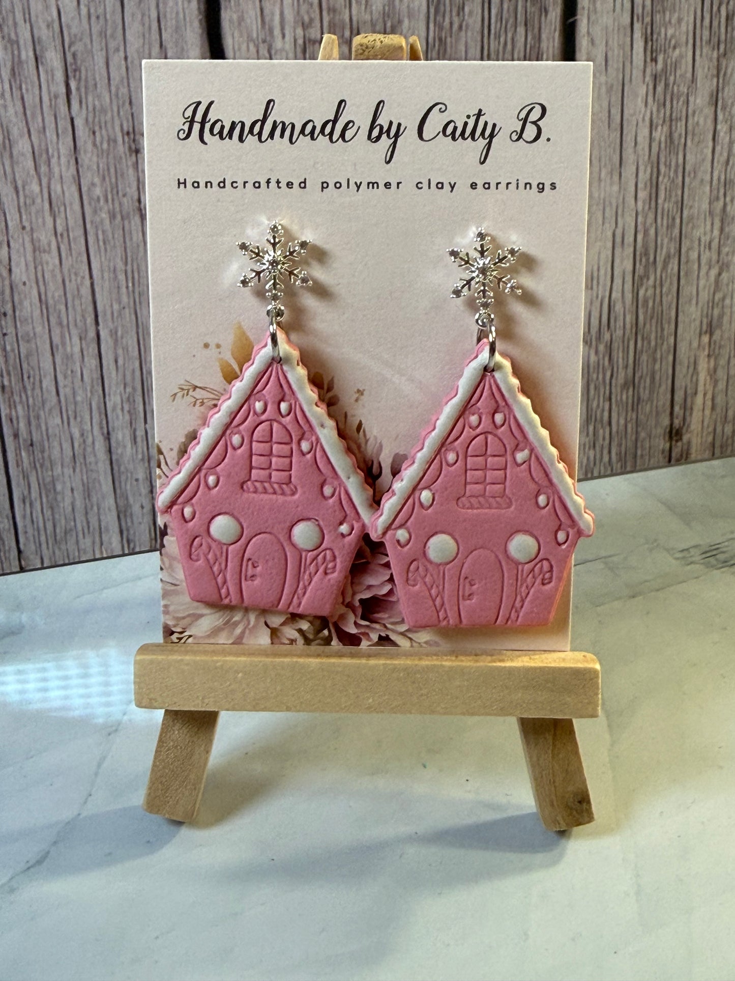 pink gingerbread house with snowflake tops