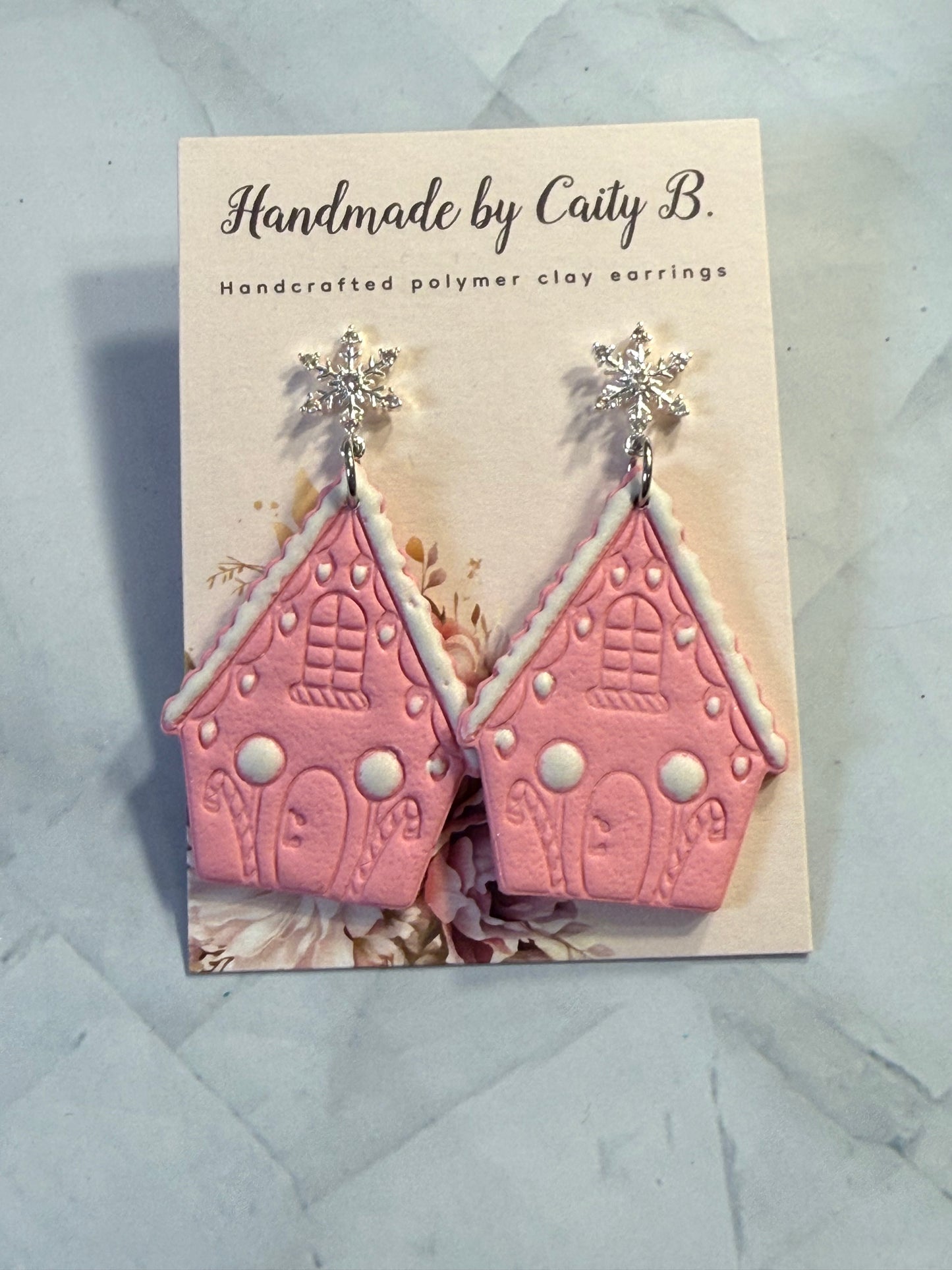 pink gingerbread house with snowflake tops