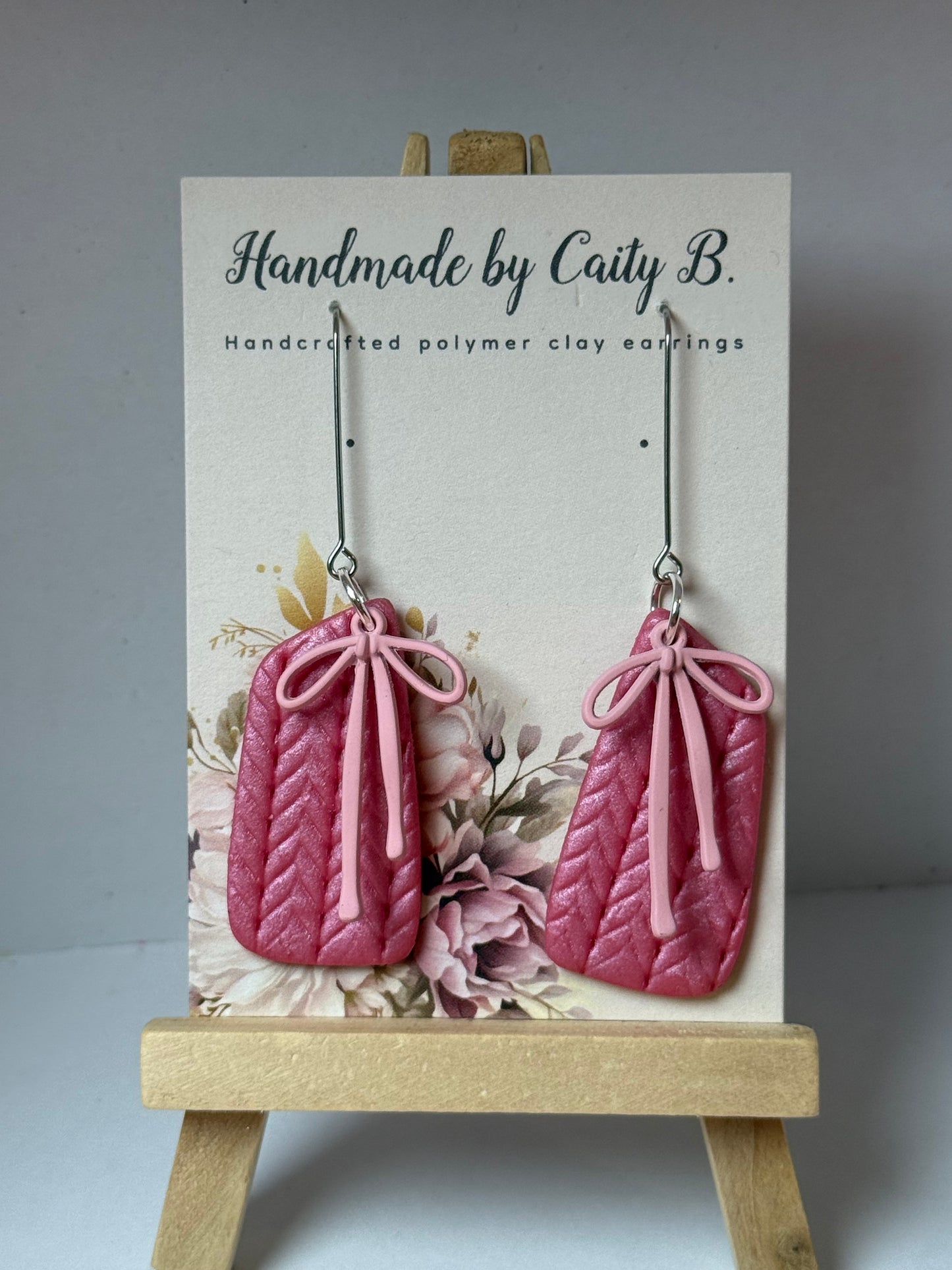 pink shimmer knitted texture earrings with pink bow charms