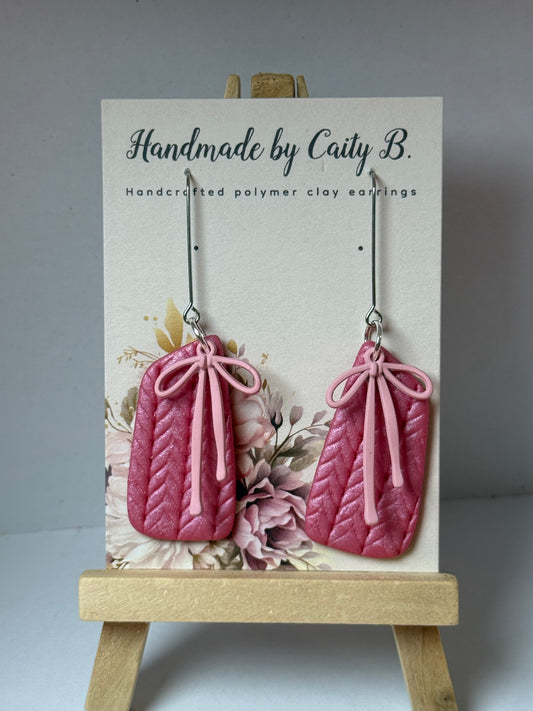 pink shimmer knitted texture earrings with pink bow charms