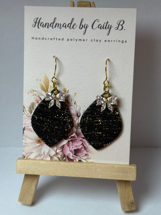 Sparkle black and gold drop earrings with bow charm