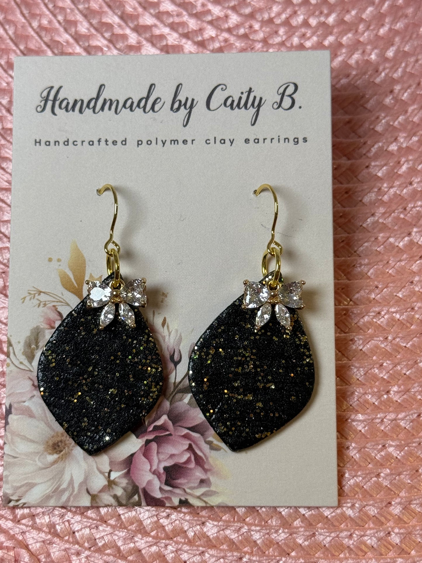 Sparkle black and gold drop earrings with bow charm