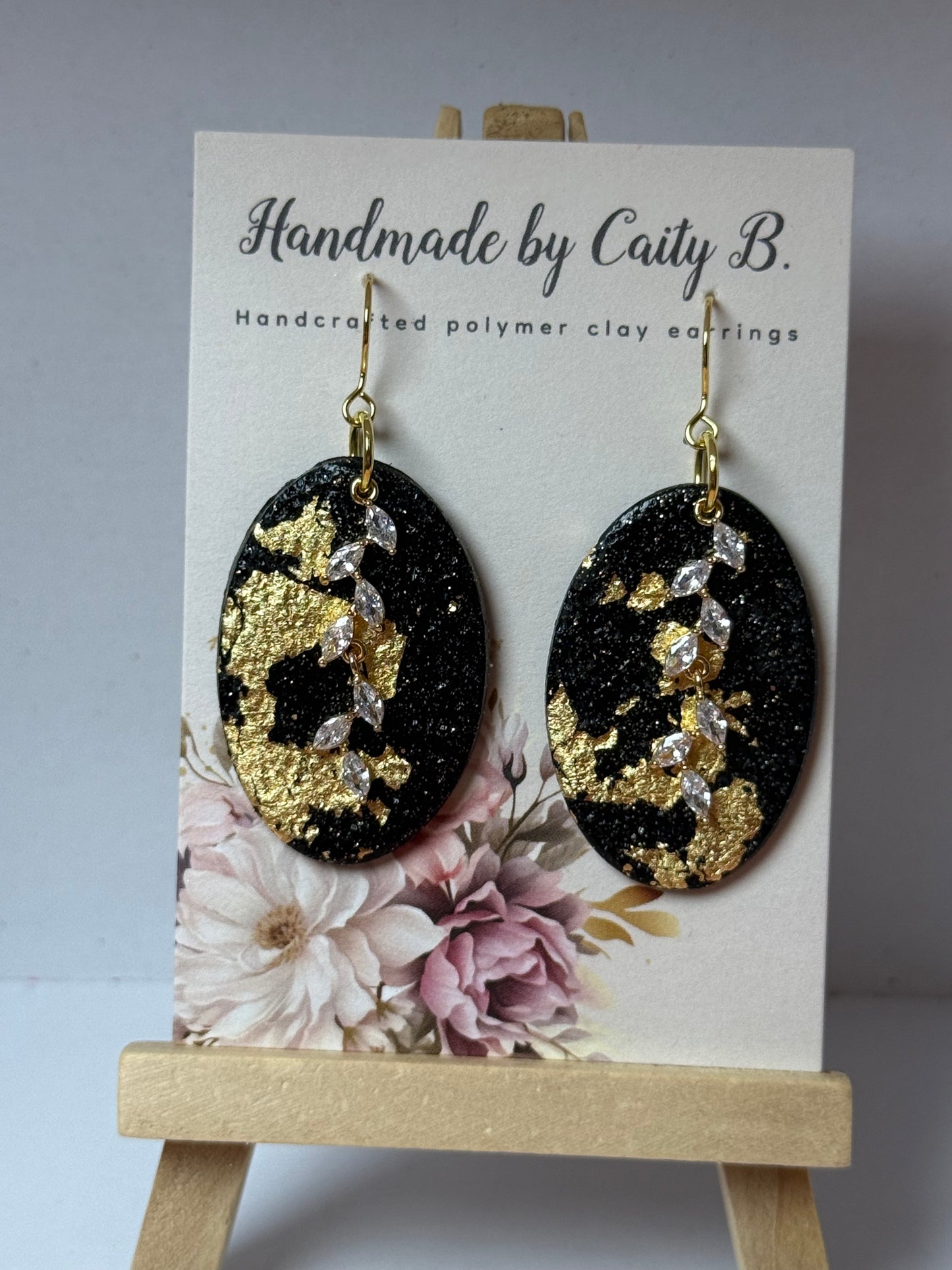 black and gold sparkle oval earrings with charms
