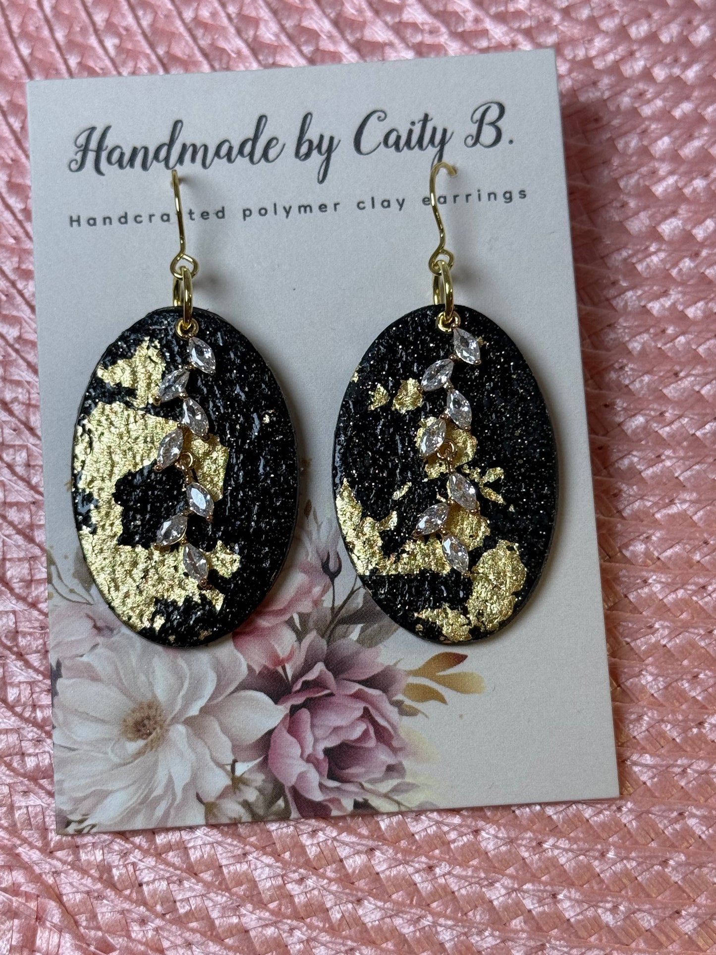 black and gold sparkle oval earrings with charms