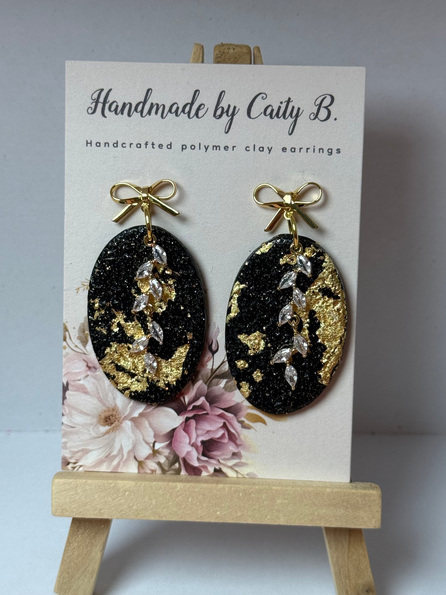 black an gold sparkle ovals with charms and bow tops