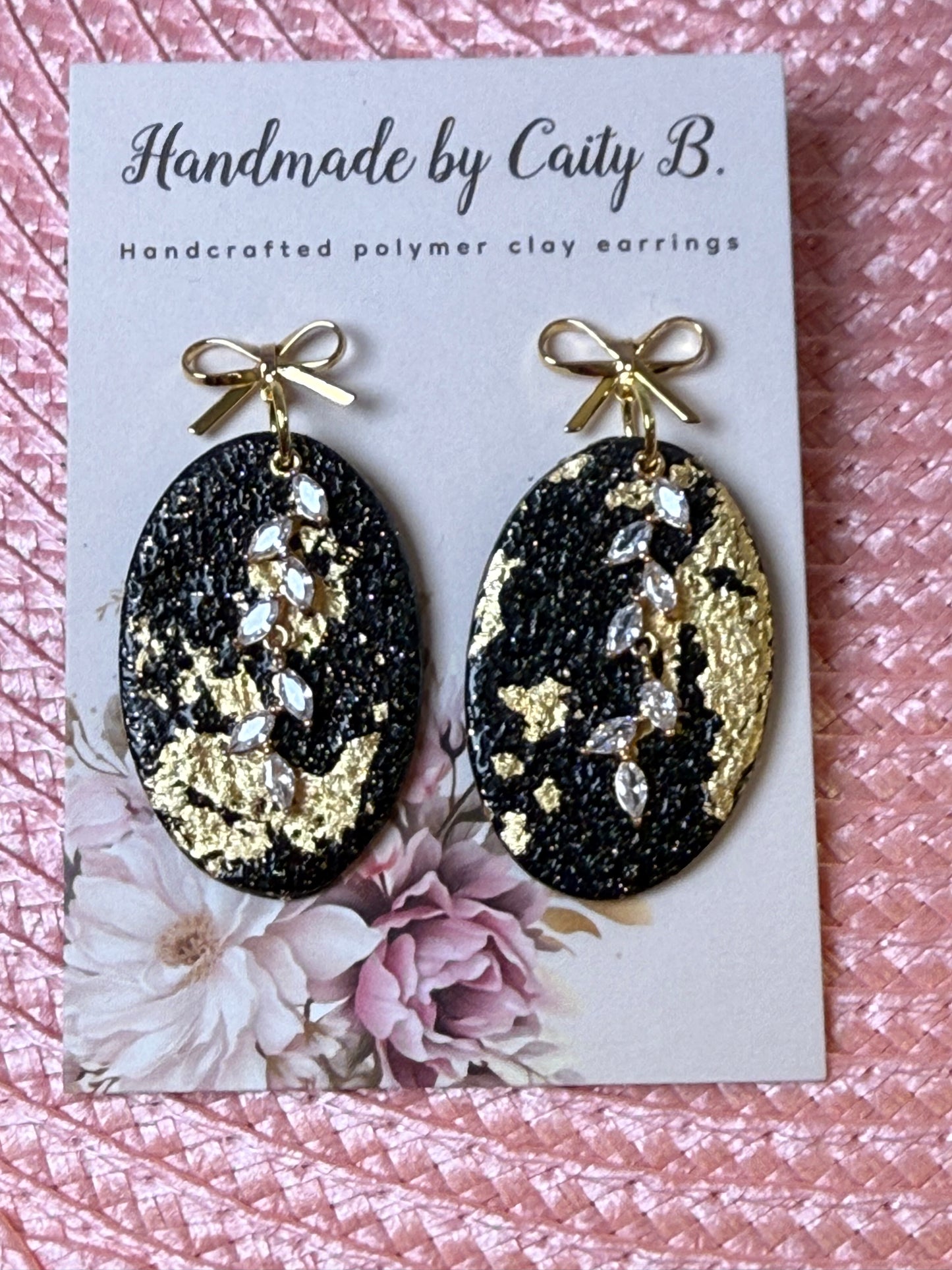 black an gold sparkle ovals with charms and bow tops