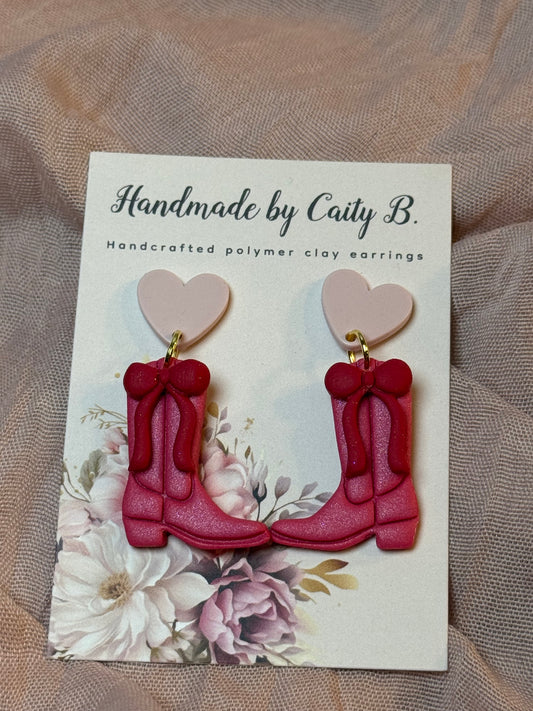 pink boots with red bows and heart toppers